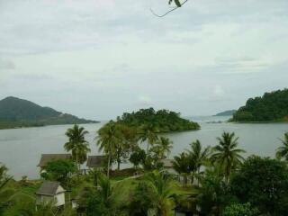 Serene lakeside view with lush greenery and distant hills