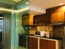 Modern kitchen with glass partition and wooden cabinets