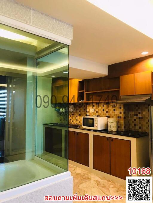 Modern kitchen with glass partition and wooden cabinets