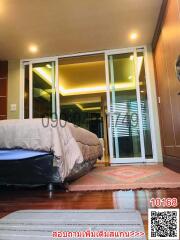 Elegant bedroom with modern sliding glass doors leading to an adjoining area