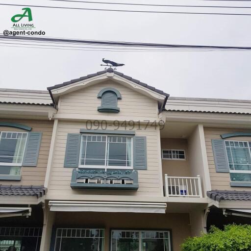 Front view of a two-story residential townhouse with decorative elements