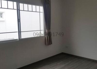 Spacious and well-lit empty bedroom with large window