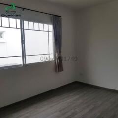 Spacious and well-lit empty bedroom with large window