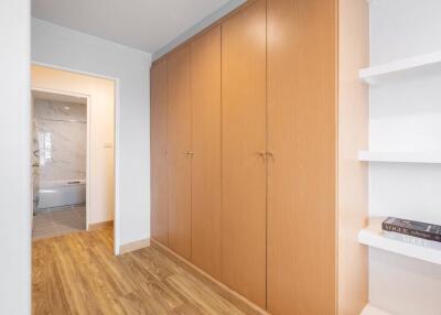 Spacious bedroom with large built-in wardrobes and wooden flooring