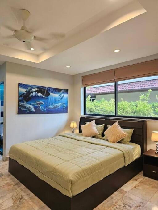 Modern bedroom with large bed and artistic decor
