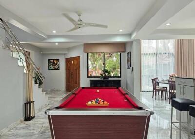 Spacious living area with pool table and elegant marble flooring