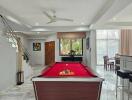 Spacious living area with pool table and elegant marble flooring