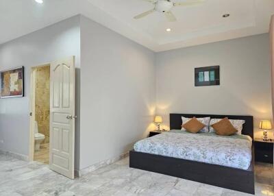 Spacious and well-lit bedroom with ensuite bathroom