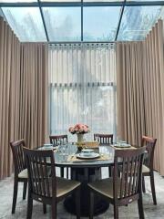 Elegant dining room with large window and stylish curtains