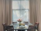 Elegant dining room with large window and stylish curtains