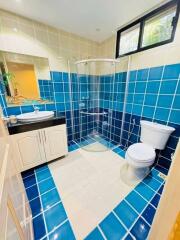Bright and modern bathroom with blue and beige tiles