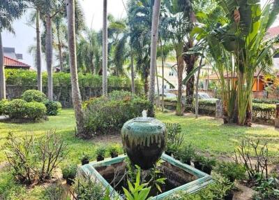 Lush garden with water feature and tropical plants