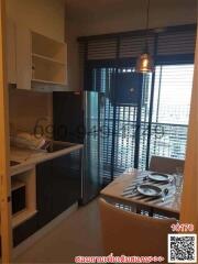 Modern compact kitchen with dining area and natural lighting