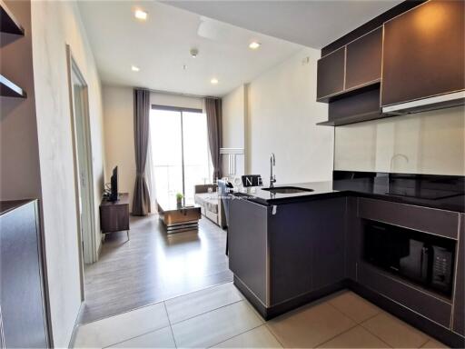 Modern kitchen with open plan leading to living area