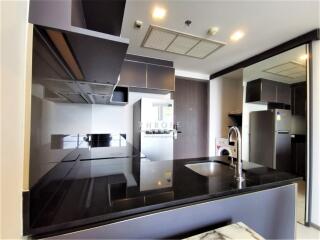 Modern kitchen with black countertops and built-in appliances