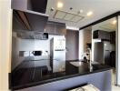 Modern kitchen with black countertops and built-in appliances