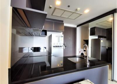 Modern kitchen with black countertops and built-in appliances