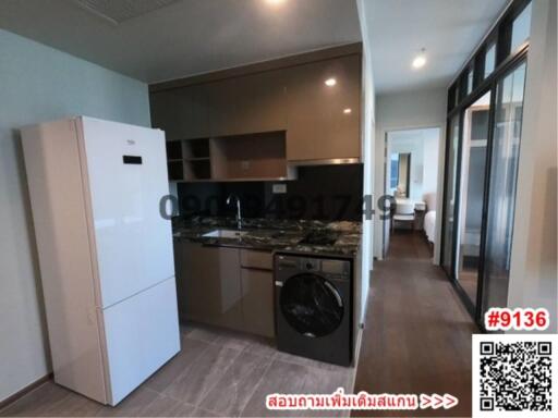 Modern kitchen with appliances and open layout connecting to a living area