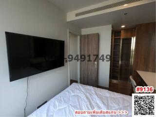 Modern bedroom with wall-mounted TV and sliding door wardrobe