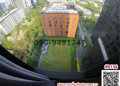 Aerial view of a modern apartment building with surrounding green spaces