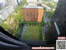 Aerial view of a modern apartment building with surrounding green spaces