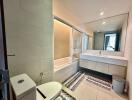 Spacious modern bathroom with large mirror and bathtub