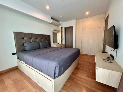 Modern bedroom with wooden flooring and stylish decor