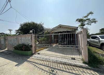 Exterior view of a residential house with gated entrance