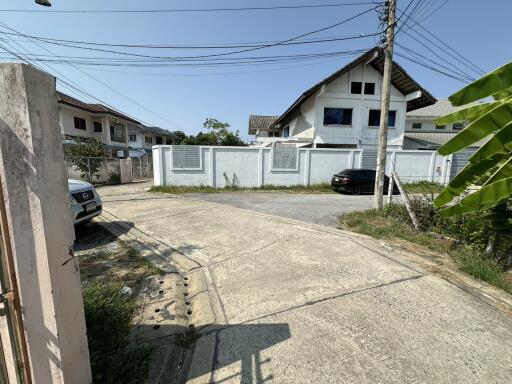 Suburban neighborhood view showing gated houses and paved road