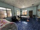 Spacious living room with blue tile flooring and large windows