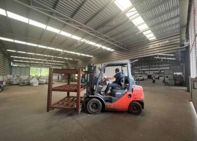 Spacious warehouse interior with forklift and pallets