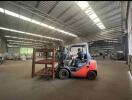 Spacious warehouse interior with forklift and pallets