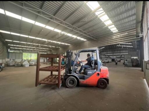 Spacious warehouse interior with forklift and pallets