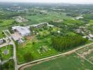 Aerial view of a large property with surrounding greenery and industrial buildings