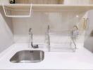 Modern white kitchen sink with sleek fixtures and storage solutions