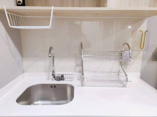 Modern white kitchen sink with sleek fixtures and storage solutions