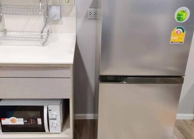 Modern kitchen with stainless steel refrigerator and built-in dishwasher