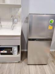 Modern kitchen with stainless steel refrigerator and built-in dishwasher