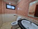 Spacious bathroom with tiled walls and modern fixtures