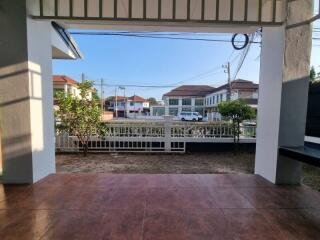 Spacious front porch of a residential home with a view of a tranquil neighborhood