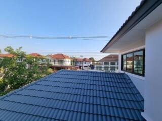 View from upper floor showcasing roofs and residential neighborhood