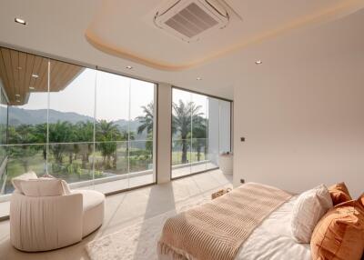 Spacious bedroom with large windows and scenic view