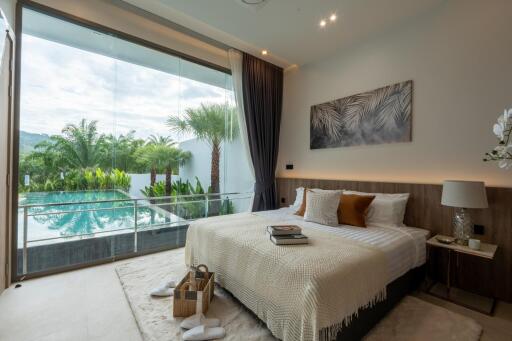 Luxurious bedroom overlooking a tropical pool and garden