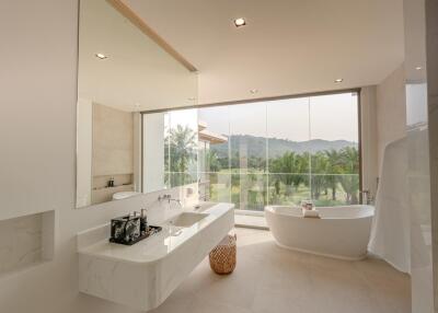 Spacious modern bathroom with large windows and scenic view