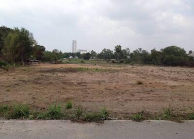 Empty lot available for development with a distant view of a high-rise building