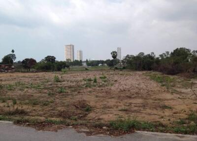 Vacant land with distant high-rise buildings