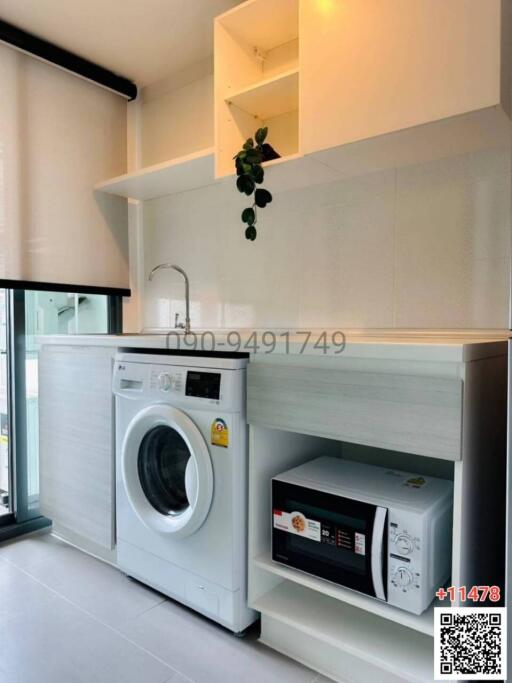 Modern kitchen with laundry appliances
