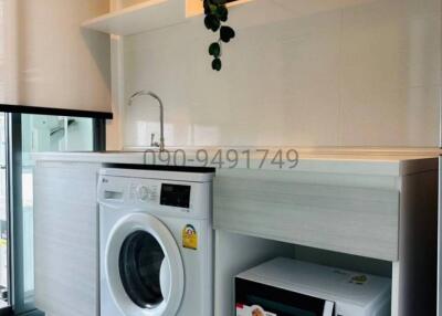 Modern kitchen with laundry appliances