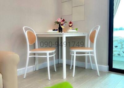 Elegant small dining area with white furniture and natural light