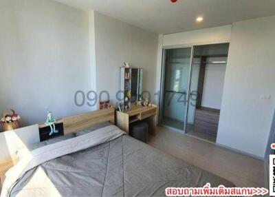 Modern bedroom with large bed and access to balcony